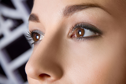 Close up studio portrait of young woman's eyes
